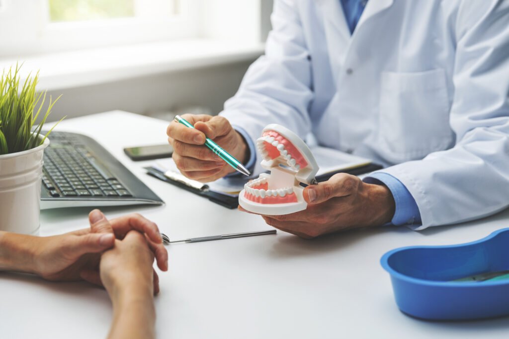 Dentist discussing dental implant treatment options with a patient