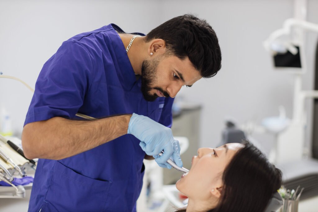 Dentist treating a patient at Batth Dental Clinic, Zira